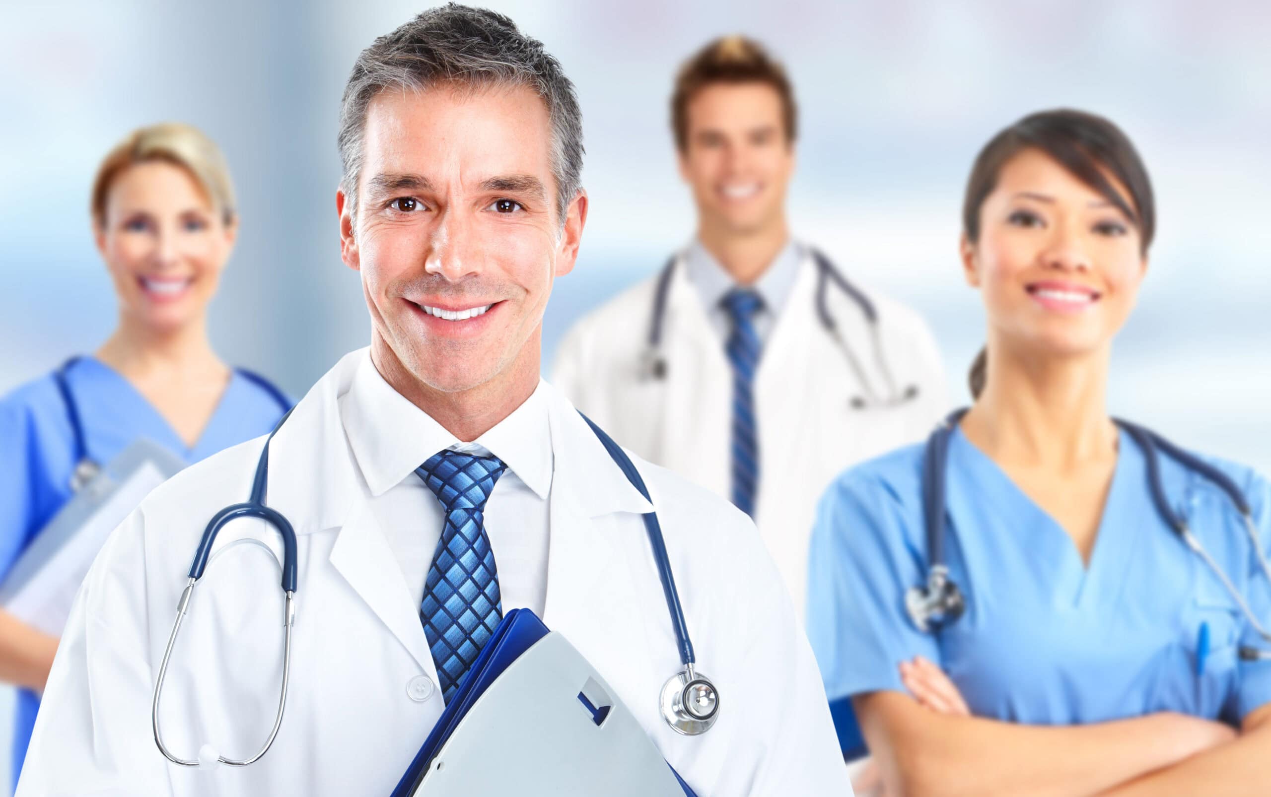 2 Men in doctors coats and 2 women in nurses clothing